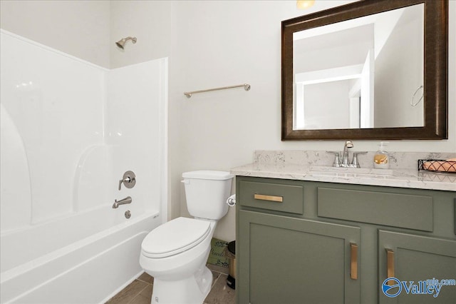 full bathroom with tile patterned floors, vanity, shower / bath combination, and toilet