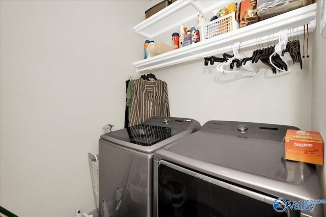 clothes washing area with separate washer and dryer