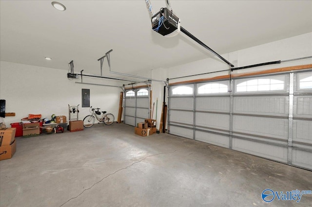 garage with electric panel and a garage door opener