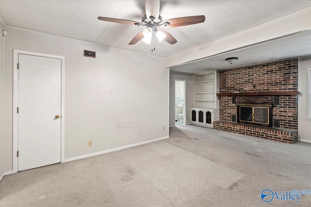 unfurnished living room featuring built in shelves, a textured ceiling, ornamental molding, and carpet