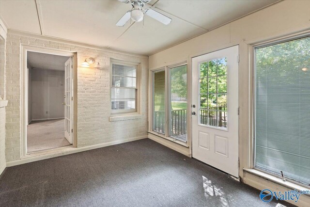 unfurnished sunroom featuring ceiling fan