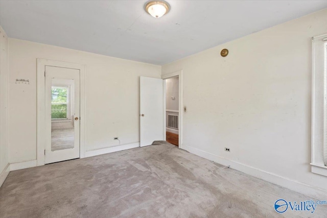 carpeted empty room with visible vents and baseboards