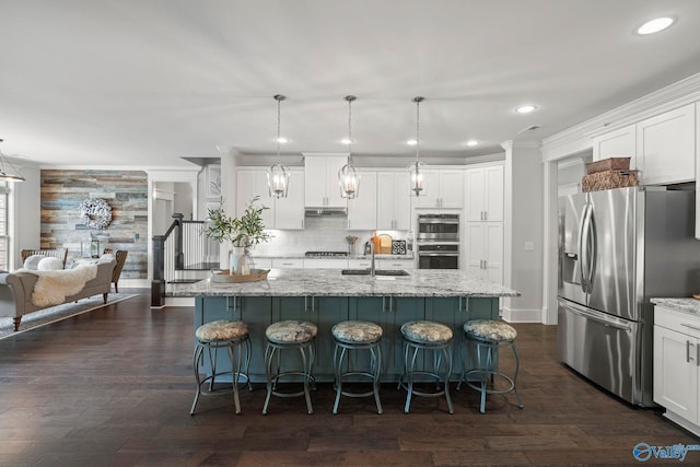 155 Holbrook Dr, Huntsville, AL 35806 - kitchen featuring stainless steel appliances, white cabinetry, a breakfast bar area, recessed lighting, and crown molding