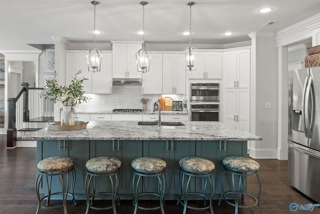 155 Holbrook Dr, Huntsville, AL 35806 - kitchen with stainless steel appliances, under cabinet range hood, white cabinets, tasteful backsplash, and crown molding