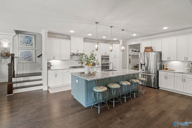 155 Holbrook Dr, Huntsville, AL 35806 - kitchen with appliances with stainless steel finishes, tasteful backsplash, white cabinets, a center island with sink, and a kitchen breakfast bar