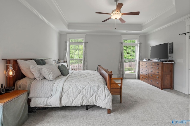 155 Holbrook Dr, Huntsville, AL 35806 - carpeted bedroom featuring multiple windows, ornamental molding, a tray ceiling, and a ceiling fan