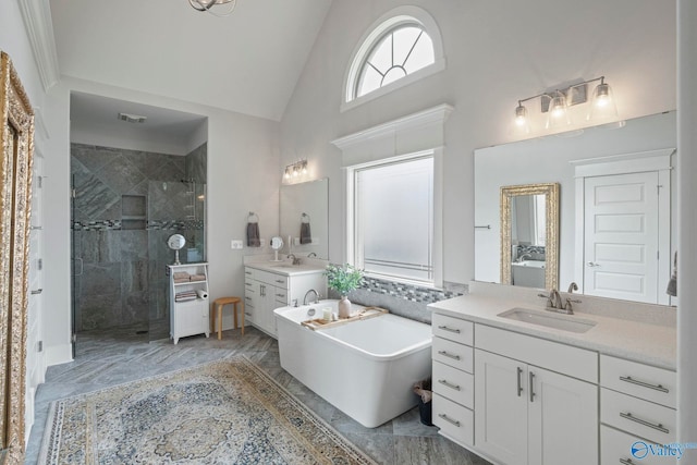 155 Holbrook Dr, Huntsville, AL 35806 - bathroom featuring a shower stall, two vanities, high vaulted ceiling, a freestanding bath, and marble finish floors