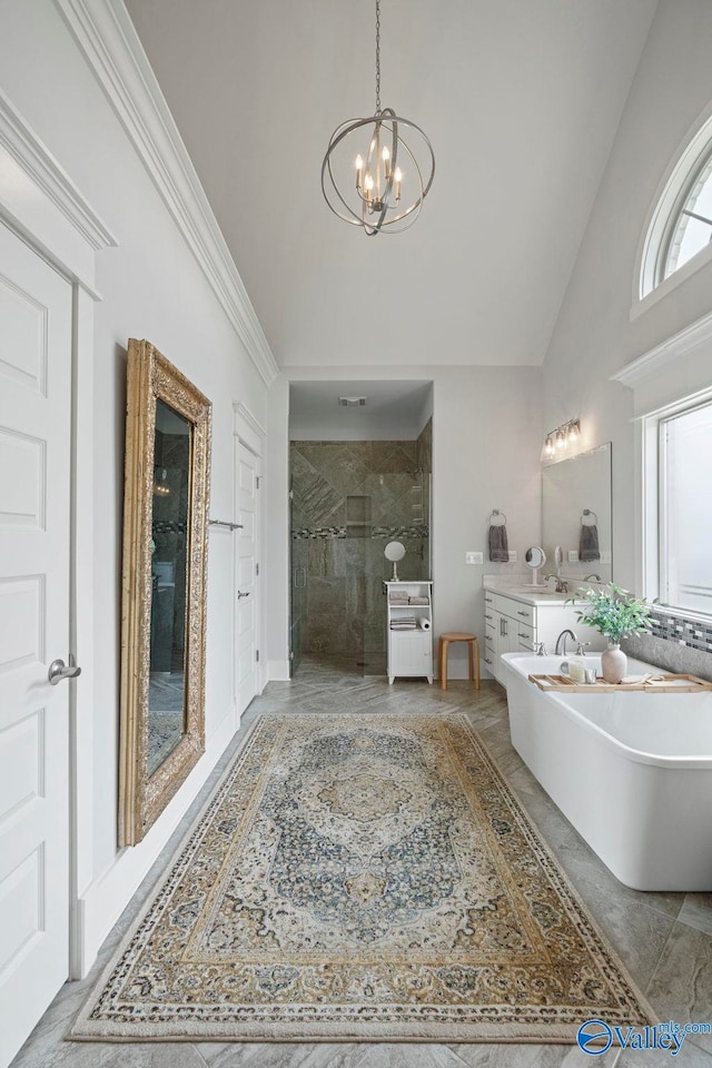 155 Holbrook Dr, Huntsville, AL 35806 - full bathroom featuring high vaulted ceiling, a chandelier, a shower stall, a freestanding tub, and vanity