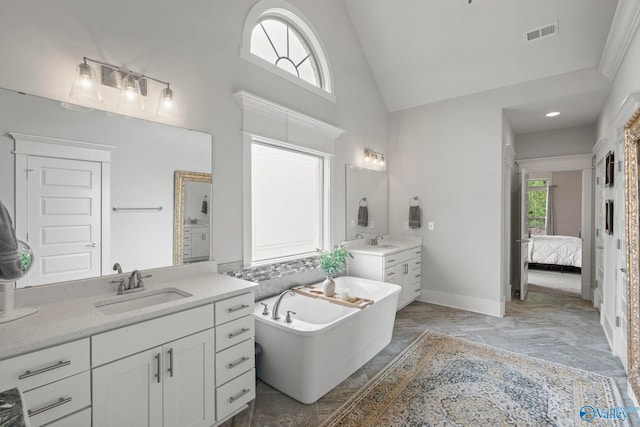 155 Holbrook Dr, Huntsville, AL 35806 - ensuite bathroom featuring two vanities, a freestanding tub, high vaulted ceiling, and marble finish flooring