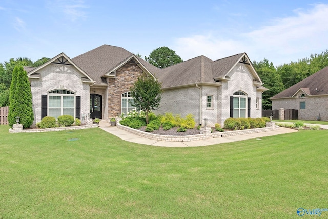 155 Holbrook Dr, Huntsville, AL 35806 - view of front of house featuring brick siding, a front lawn, and roof with shingles