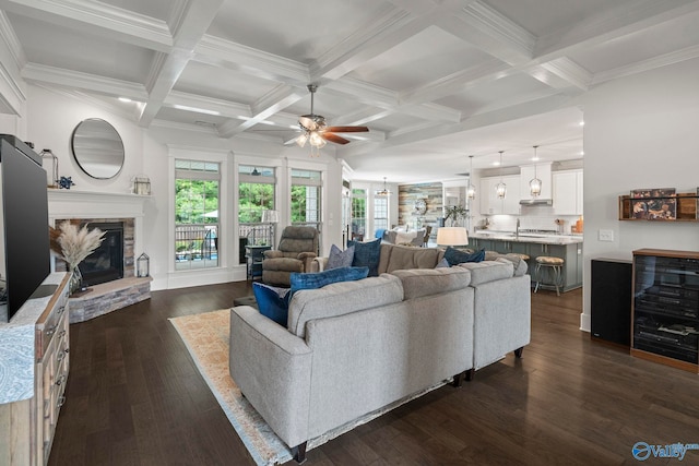 155 Holbrook Dr, Huntsville, AL 35806 - living area with ceiling fan, coffered ceiling, dark wood-style floors, beam ceiling, and a stone fireplace