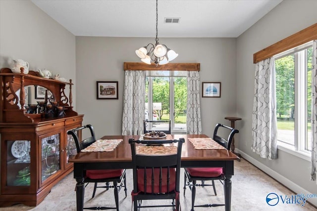 dining room featuring visible vents, plenty of natural light, baseboards, and an inviting chandelier