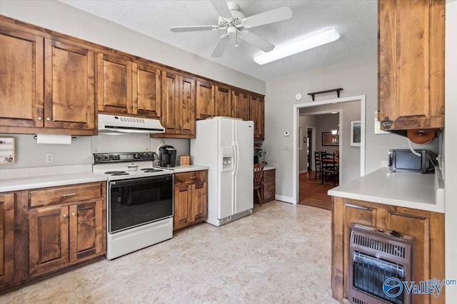 kitchen featuring heating unit, under cabinet range hood, white appliances, light countertops, and brown cabinets