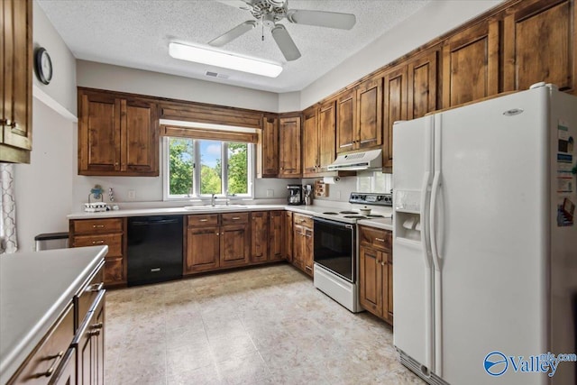 kitchen featuring under cabinet range hood, white appliances, a sink, visible vents, and light countertops