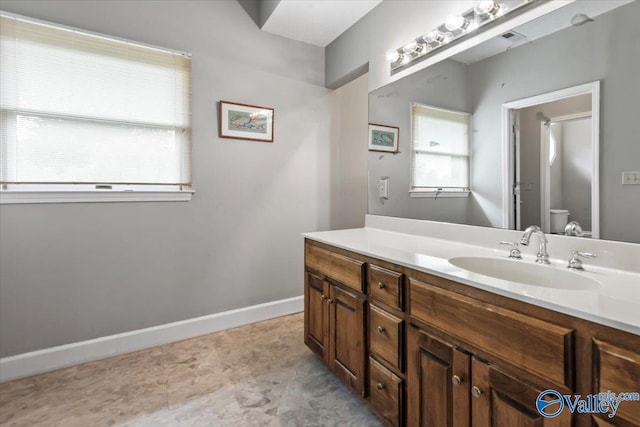 full bath featuring visible vents, vanity, toilet, and baseboards