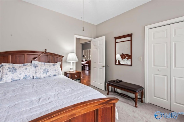 bedroom with a closet and light colored carpet