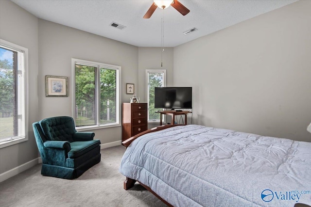 bedroom featuring multiple windows, visible vents, and carpet flooring