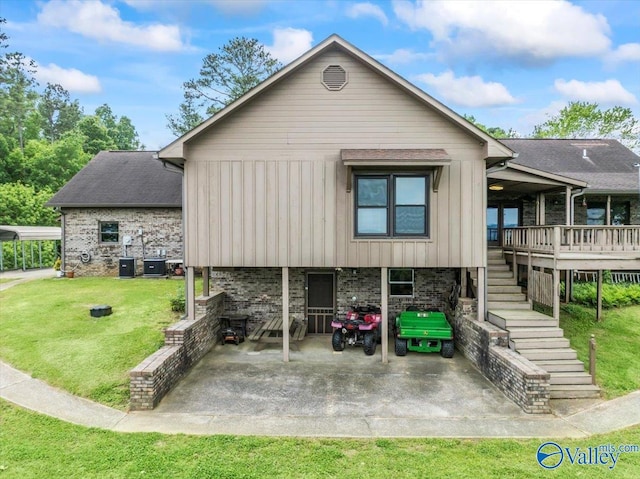 view of front facade featuring stairs, a patio area, a front yard, board and batten siding, and brick siding