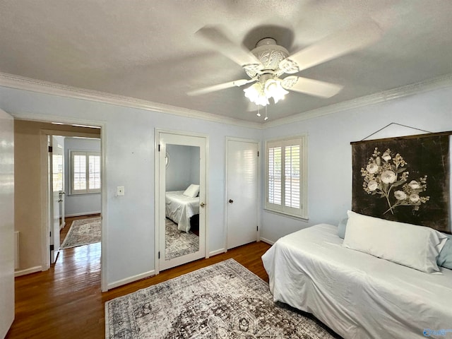 bedroom featuring multiple windows, wood-type flooring, ceiling fan, and crown molding