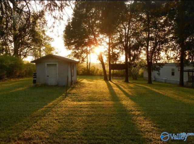 yard at dusk with a storage shed