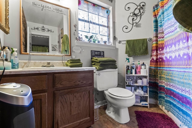 bathroom featuring vanity, toilet, and tile patterned flooring