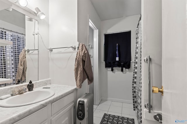 bathroom with vanity, radiator heating unit, and tile patterned flooring