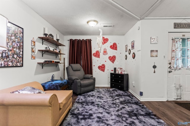 living room with wood-type flooring and a textured ceiling