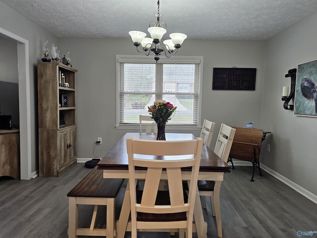 dining space with dark hardwood / wood-style flooring, a chandelier, and a textured ceiling