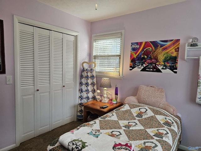 bedroom featuring a closet and dark carpet