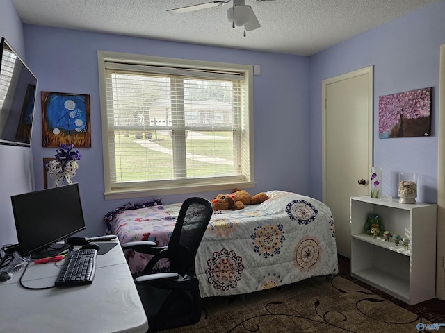 bedroom with a textured ceiling and ceiling fan