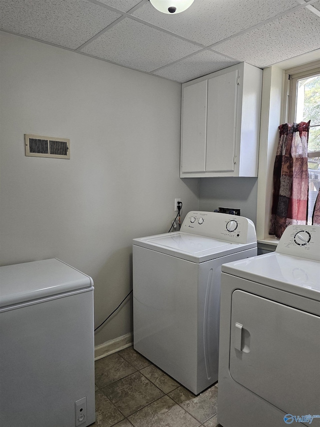 washroom with washer and clothes dryer and cabinets