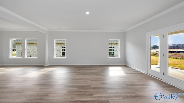 spare room with crown molding and hardwood / wood-style flooring