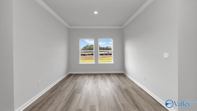 spare room with hardwood / wood-style flooring and ornamental molding