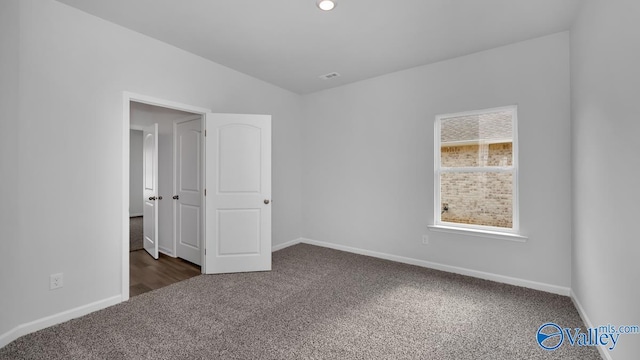 unfurnished bedroom with dark colored carpet