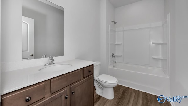 full bathroom with vanity, wood-type flooring, tub / shower combination, and toilet