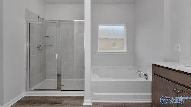 bathroom featuring vanity, hardwood / wood-style floors, and independent shower and bath