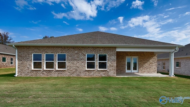 back of house with a patio area and a lawn