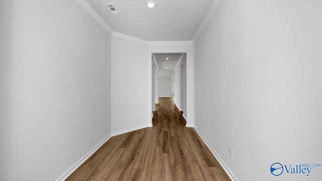 hallway featuring wood-type flooring and crown molding