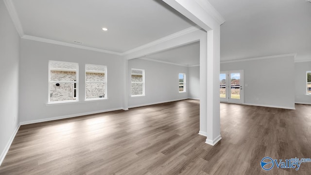 unfurnished living room featuring dark hardwood / wood-style flooring and ornamental molding