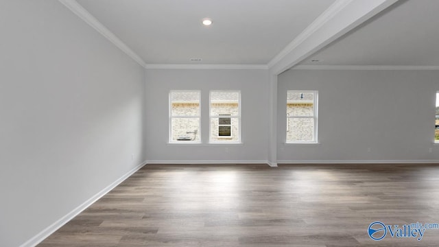 empty room with ornamental molding and hardwood / wood-style floors