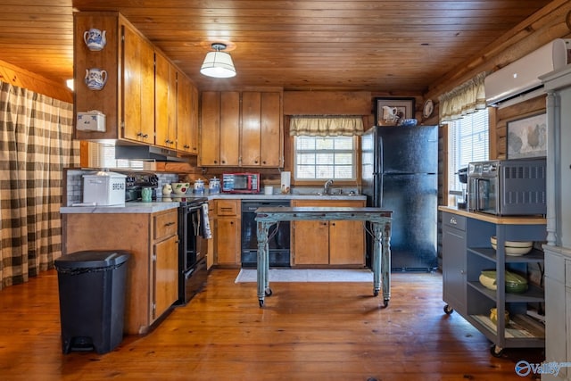 kitchen with wooden ceiling, black appliances, a wall mounted air conditioner, and light hardwood / wood-style floors