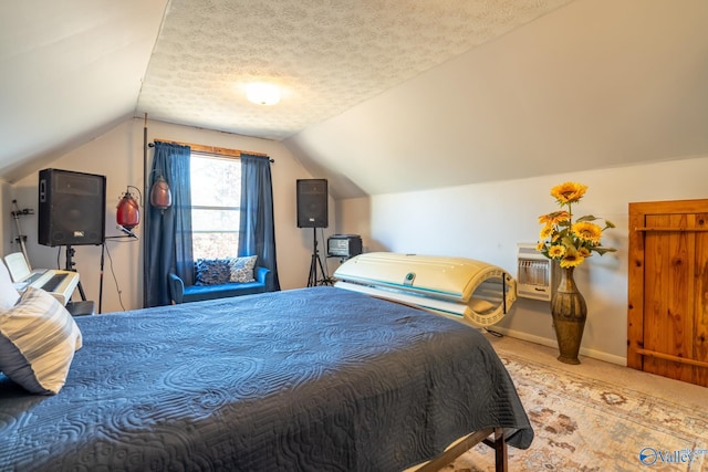 bedroom featuring a textured ceiling, light colored carpet, an AC wall unit, and lofted ceiling