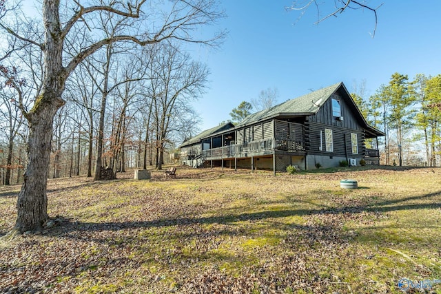 view of side of property featuring a yard and a deck