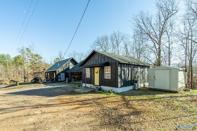 view of front of home featuring a storage shed