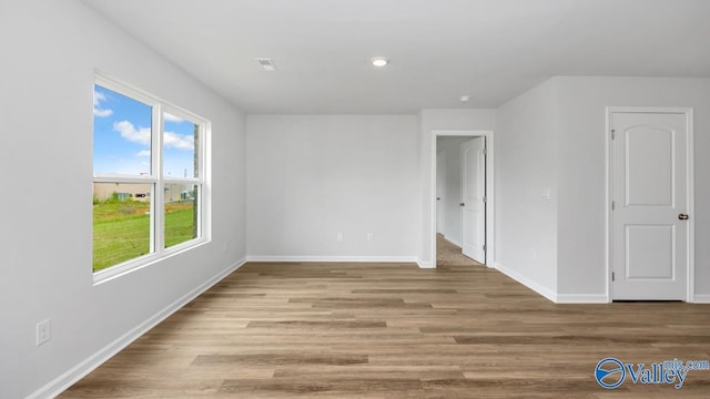 interior space featuring baseboards, wood finished floors, and recessed lighting