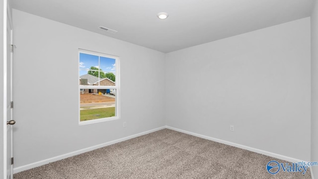 carpeted empty room with baseboards and visible vents