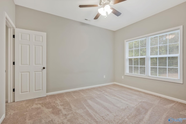 carpeted spare room with ceiling fan