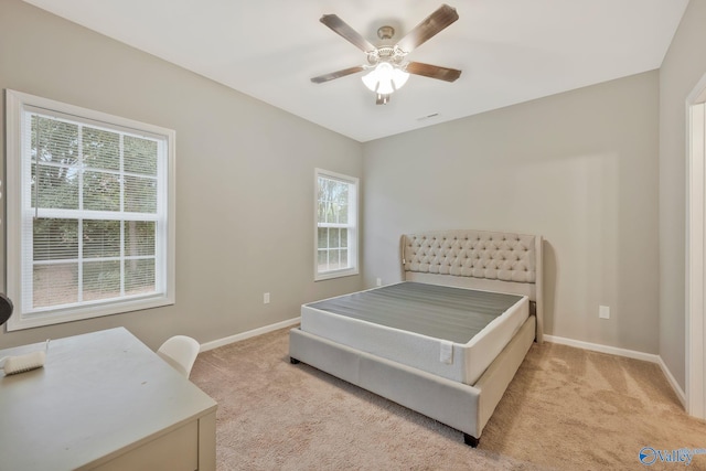 bedroom with light colored carpet and ceiling fan