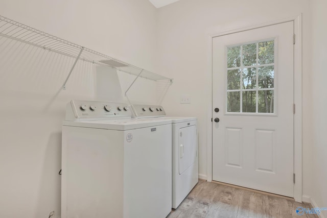 laundry area featuring light hardwood / wood-style floors and washer and dryer