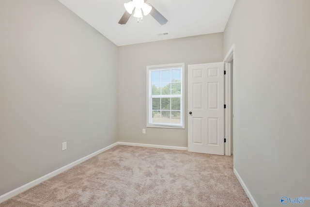 carpeted spare room featuring ceiling fan